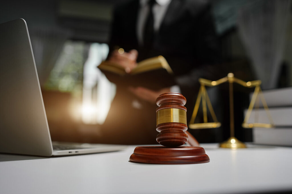 Lawyer standing infront of the table and wrtting something about the case