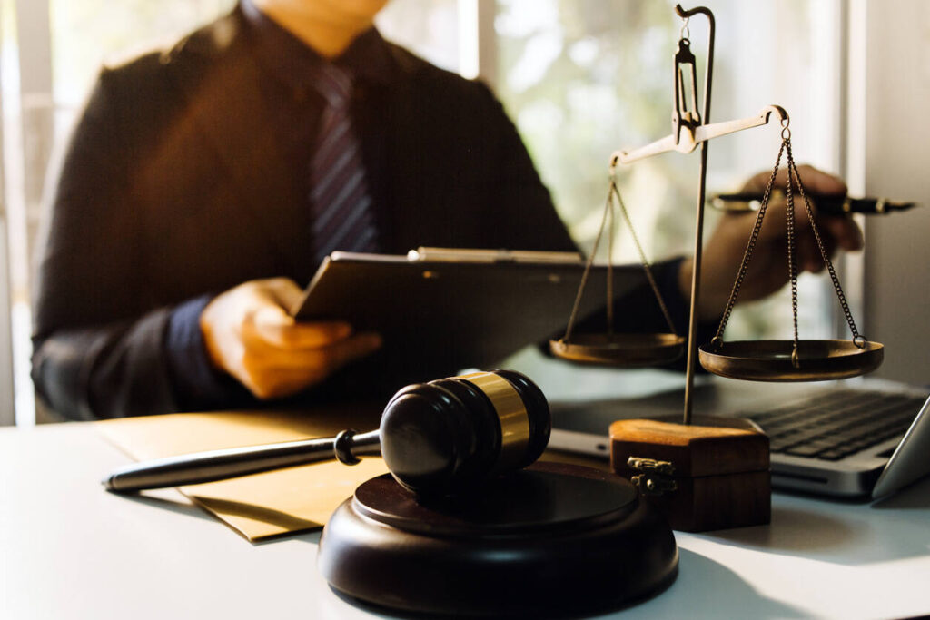 lawyer sitting on the table with gavel and reading about the case