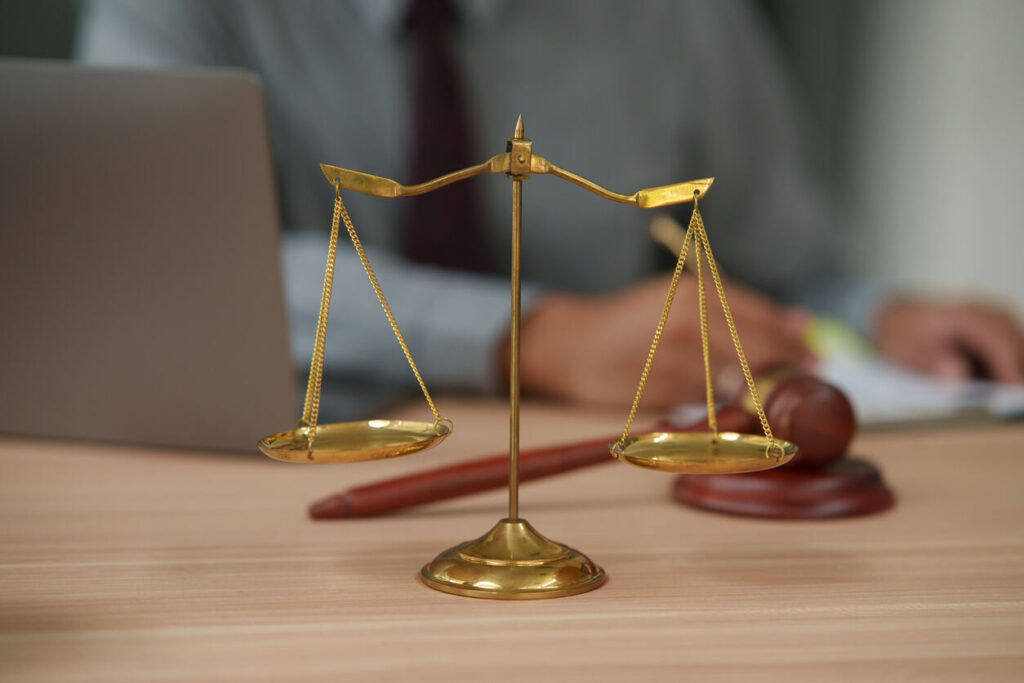 Scales of justice and gavel on desk in law office — Columbia, South Carolina assault and battery defense attorney.